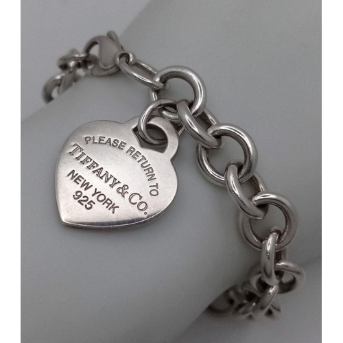 956 - A Tiffany and Co. Sterling Silver Heart Bracelet. 16cm. 32.5g. Comes with Tiffany pouch and box.