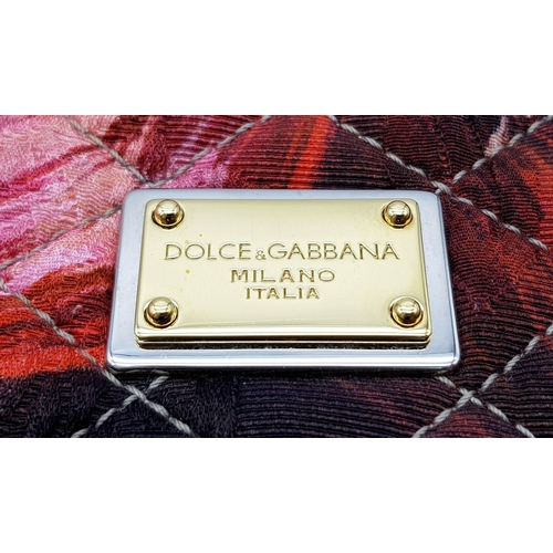 570 - A Dolce & Gabbana Quilted Printed Shoulder Bag. Multicoloured quilted fabric exterior features a vib... 