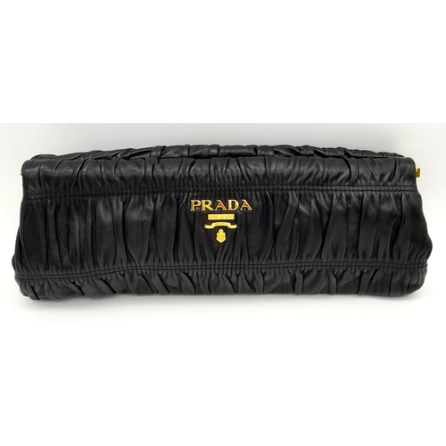 577 - A Prada Black Gathered Leather Clutch Bag. Black leather exterior with ruched detailing, gold-toned ... 