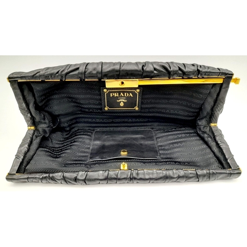 577 - A Prada Black Gathered Leather Clutch Bag. Black leather exterior with ruched detailing, gold-toned ... 