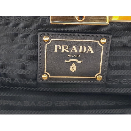 577 - A Prada Black Gathered Leather Clutch Bag. Black leather exterior with ruched detailing, gold-toned ... 