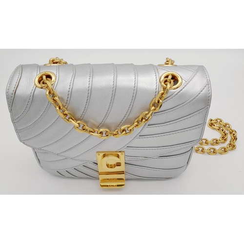 143 - A Celine Metallic Silver Quilted Shoulder Bag. Metallic silver leather exterior with quilted detaili... 