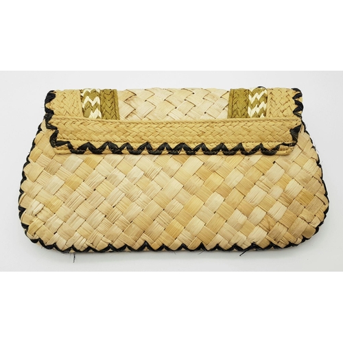 668 - An Anya Hindmarch Handwoven Straw Clutch with Black Bead Embellishments. Natural straw exterior feat... 