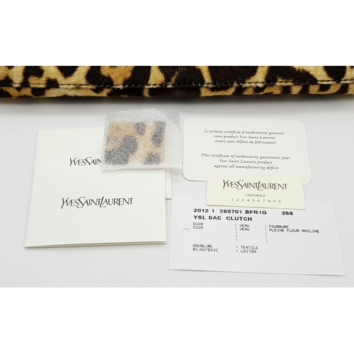 675 - A Saint Laurent Leopard Print Haircalf Cassandre Clutch. Leopard print haircalf exterior with gold-t... 