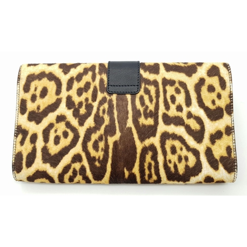 675 - A Saint Laurent Leopard Print Haircalf Cassandre Clutch. Leopard print haircalf exterior with gold-t... 