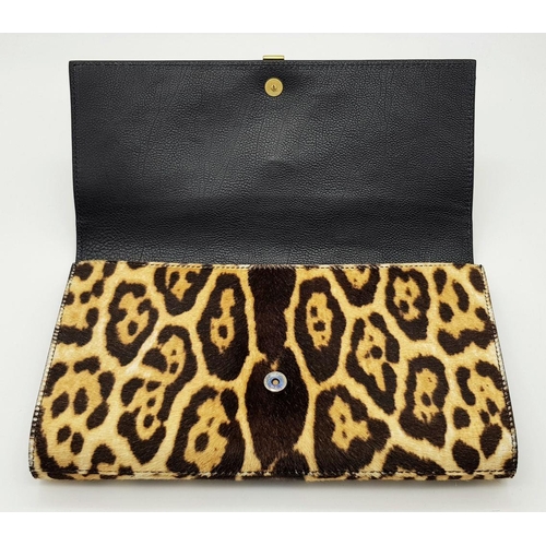 675 - A Saint Laurent Leopard Print Haircalf Cassandre Clutch. Leopard print haircalf exterior with gold-t... 