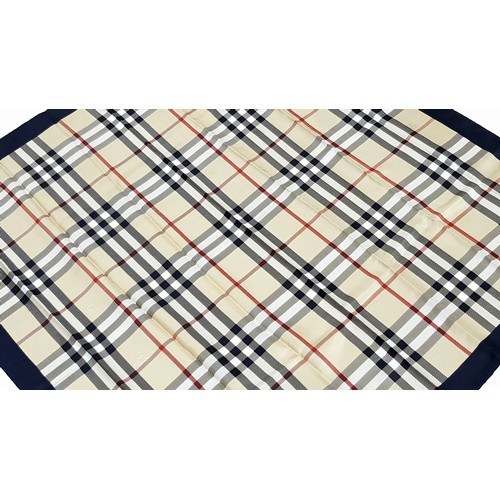 1178 - A Burberry Vintage Check Silk Scarf. Crafted from soft silk in a beige, black, and red vintage check... 