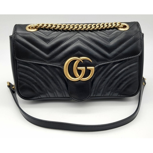 353 - A Gucci Black Marmont Matelassé Bag. Black quilted leather exterior with gold-toned hardware, chain ... 