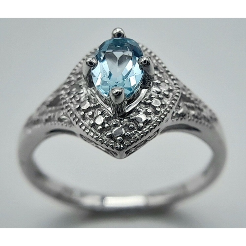 1103 - A Blue Topaz Set Sterling Silver Ring Size L. The Ring Measures 1.2cm Wide at the crown and weighs 2... 