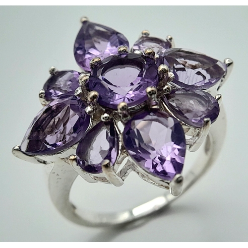 915 - A Vintage Sterling Silver Amethyst Set Cluster Ring Size P. The Ring measures 2.5 x 2.5cm at the Cro... 