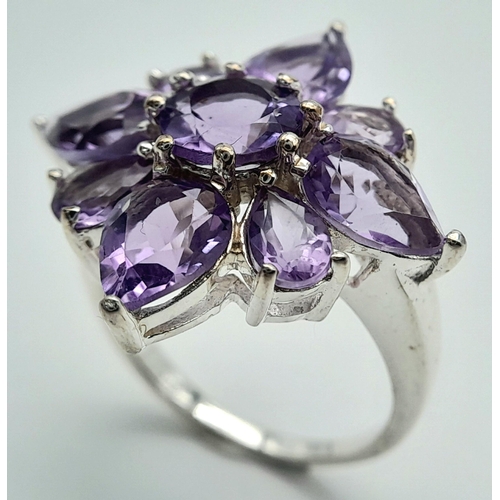 915 - A Vintage Sterling Silver Amethyst Set Cluster Ring Size P. The Ring measures 2.5 x 2.5cm at the Cro... 