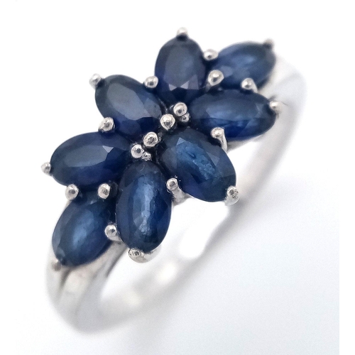 936 - A Sterling Silver and Eight Stone Blue Sapphire Ring Size Q. The Ring is Set with 4mm Oval Cut Blue ... 