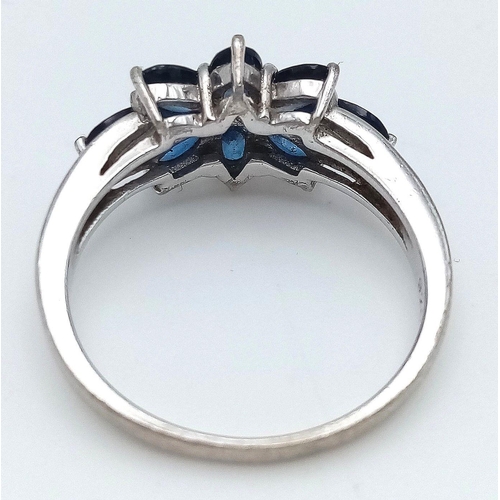 936 - A Sterling Silver and Eight Stone Blue Sapphire Ring Size Q. The Ring is Set with 4mm Oval Cut Blue ... 