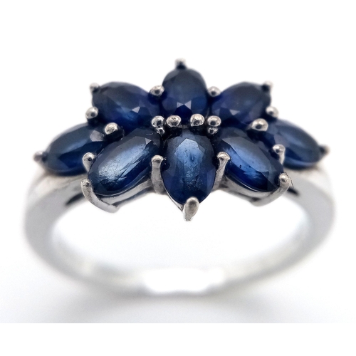 936 - A Sterling Silver and Eight Stone Blue Sapphire Ring Size Q. The Ring is Set with 4mm Oval Cut Blue ... 