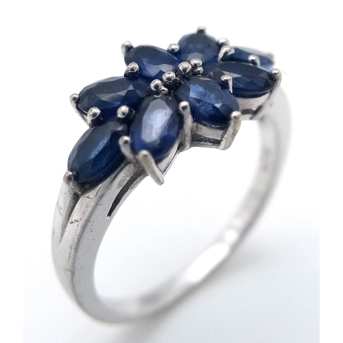 936 - A Sterling Silver and Eight Stone Blue Sapphire Ring Size Q. The Ring is Set with 4mm Oval Cut Blue ... 