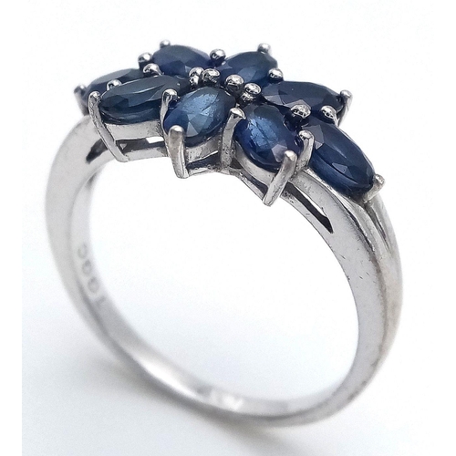 936 - A Sterling Silver and Eight Stone Blue Sapphire Ring Size Q. The Ring is Set with 4mm Oval Cut Blue ... 