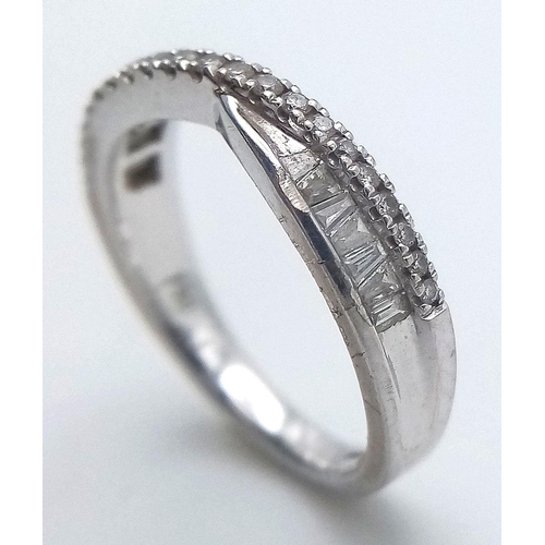 135 - AN 18K WHITE GOLD CROSSOVER MIXED CUT DIAMOND RING. 0.25CT. 3.35G IN WEIGHT. SIZE J. Ref: SC 1046