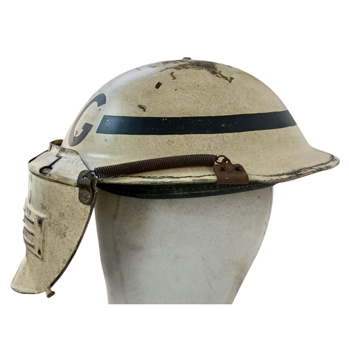 162 - A WW2 British Home Front Fire Guards Helmet with a private purchase “Quick Action” Visor attachment.