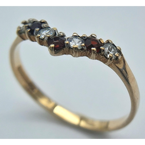 203 - Traditional 9 CARAT GOLD WISHBONE RING. Set with GARNETS and SPARKLING ZIRCONIAS. 1.2 grams. Size O ... 