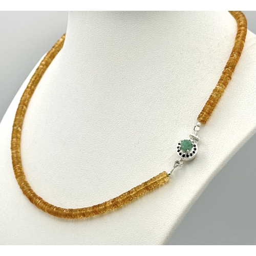 249 - An 85ct AAA quality citrine gemstone necklace featuring faceted citrine beads and an emerald-accente... 