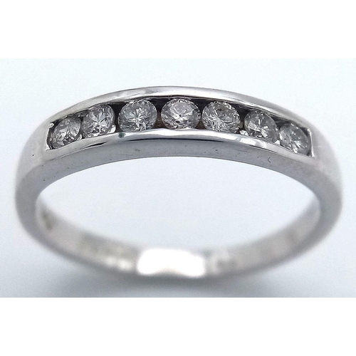 254 - AN 18K WHITE GOLD DIAMOND HALF ETERNITY RING CHANNEL SET. 0.28CT DIAMONDS, 2.56G TOTAL WEIGHT. SIZE ... 