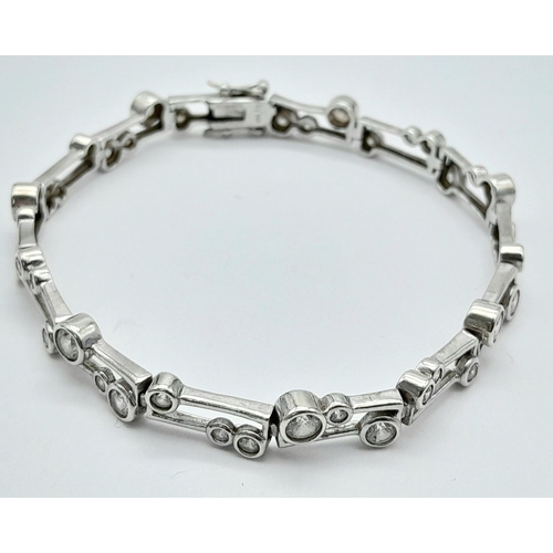 287 - Beautiful SILVER TENNIS BRACELET tramline set with Round Cut ZIRCONIA GEMSTONES.19 cm.