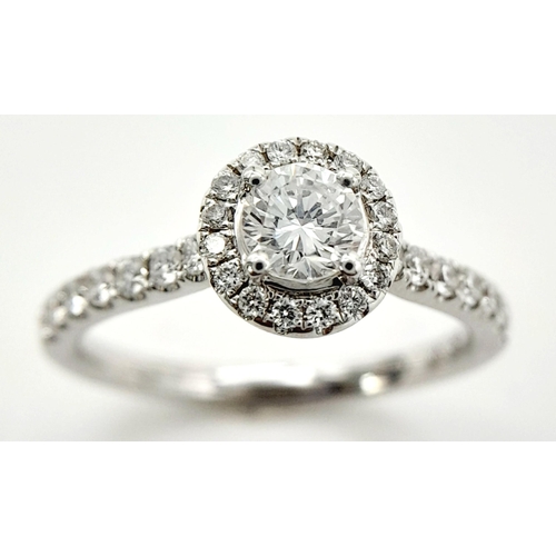 44 - AN 18K WHITE GOLD DIAMOND HALO RING 0.35CT ROUND MAIN STONE WITH 0.40CT HALO AND SHOULDER DIAMONDS. ... 