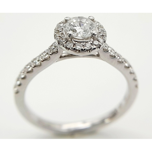 44 - AN 18K WHITE GOLD DIAMOND HALO RING 0.35CT ROUND MAIN STONE WITH 0.40CT HALO AND SHOULDER DIAMONDS. ... 