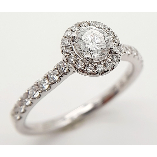 44 - AN 18K WHITE GOLD DIAMOND HALO RING 0.35CT ROUND MAIN STONE WITH 0.40CT HALO AND SHOULDER DIAMONDS. ... 