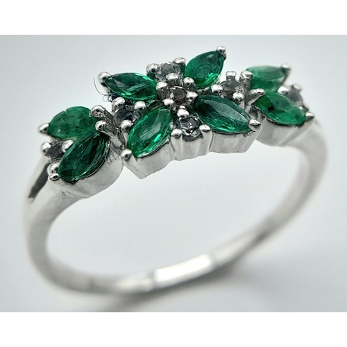 655 - A Sterling Silver Emerald and White Topaz Set Ring Size O. The Ring is Marquis Cut Emeralds and Roun... 