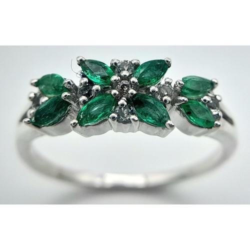 655 - A Sterling Silver Emerald and White Topaz Set Ring Size O. The Ring is Marquis Cut Emeralds and Roun... 