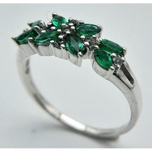 655 - A Sterling Silver Emerald and White Topaz Set Ring Size O. The Ring is Marquis Cut Emeralds and Roun... 