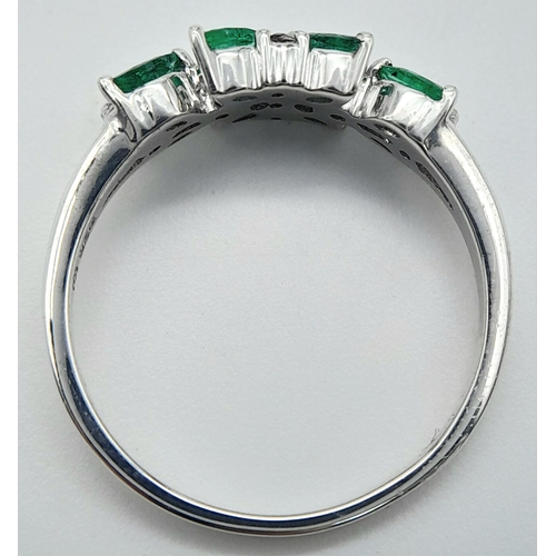 655 - A Sterling Silver Emerald and White Topaz Set Ring Size O. The Ring is Marquis Cut Emeralds and Roun... 