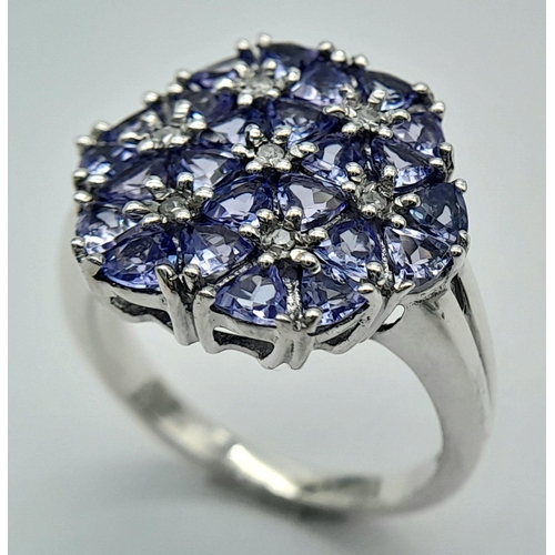 669 - A Beautiful Sterling Silver Tanzanite and Diamond Set Ring Size P. The Crown measures 1.7cm Wide and... 