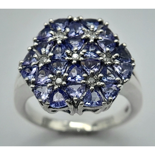 669 - A Beautiful Sterling Silver Tanzanite and Diamond Set Ring Size P. The Crown measures 1.7cm Wide and... 