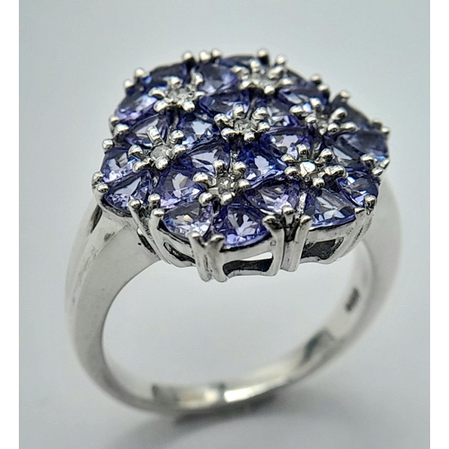 669 - A Beautiful Sterling Silver Tanzanite and Diamond Set Ring Size P. The Crown measures 1.7cm Wide and... 