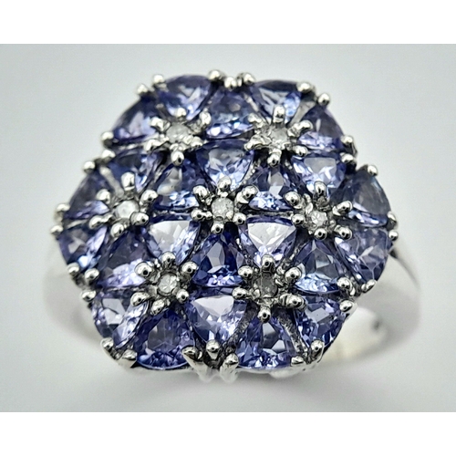 669 - A Beautiful Sterling Silver Tanzanite and Diamond Set Ring Size P. The Crown measures 1.7cm Wide and... 