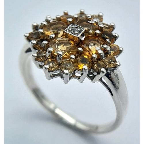 676 - An Elegant Sterling Silver Citrine and Diamond Ring Size O. The Crown measures 1.5cm Diameter and th... 