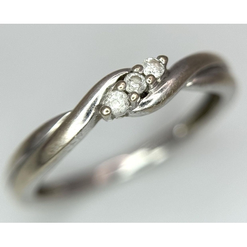 612 - A 9K White Gold Diamond Trilogy Crossover Ring. Size L 1/2. 
1.7g total weight.