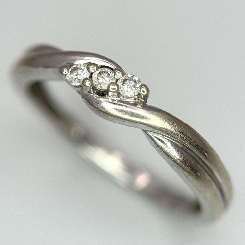 612 - A 9K White Gold Diamond Trilogy Crossover Ring. Size L 1/2. 
1.7g total weight.