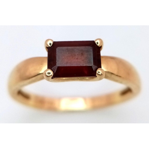 605 - A 14K Yellow Gold Garnet Solitaire Ring. Rectangular step cut. Size N 1/2. 2.6g total weight.