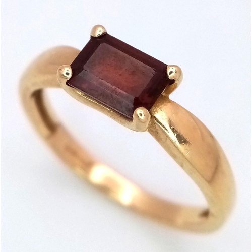 605 - A 14K Yellow Gold Garnet Solitaire Ring. Rectangular step cut. Size N 1/2. 2.6g total weight.