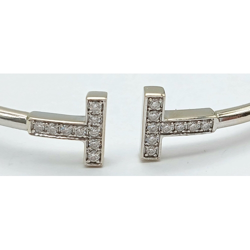 117 - An 18K White Gold Diamond Cuff Bangle. 9.9g total weight. NL9504