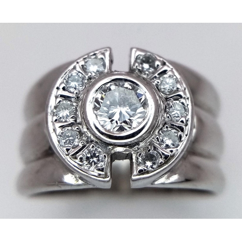 138 - An 18K White Gold and Diamond Ring. 0.30ct central stone with 0.30ctw of diamond accents. Size M. 8.... 