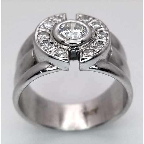 138 - An 18K White Gold and Diamond Ring. 0.30ct central stone with 0.30ctw of diamond accents. Size M. 8.... 