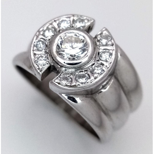 138 - An 18K White Gold and Diamond Ring. 0.30ct central stone with 0.30ctw of diamond accents. Size M. 8.... 