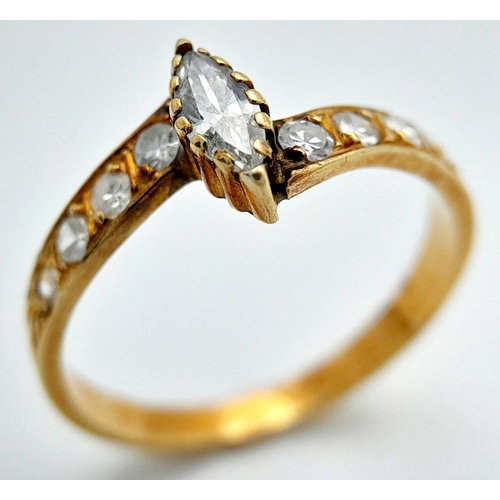 460 - An 18k Yellow Gold Diamond Crossover Ring. Central marquise and round cut diamonds. 0.5ctw approx. S... 