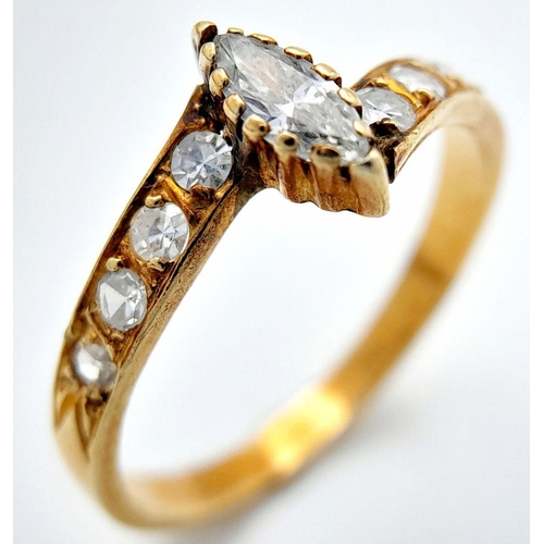 460 - An 18k Yellow Gold Diamond Crossover Ring. Central marquise and round cut diamonds. 0.5ctw approx. S... 