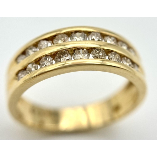 409 - An 18K Yellow Gold Two Row Diamond Ring. 18 channel set diamonds - 0.75ctw approx. Size P 1/2. 5.2g ... 