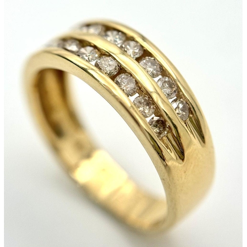 409 - An 18K Yellow Gold Two Row Diamond Ring. 18 channel set diamonds - 0.75ctw approx. Size P 1/2. 5.2g ... 